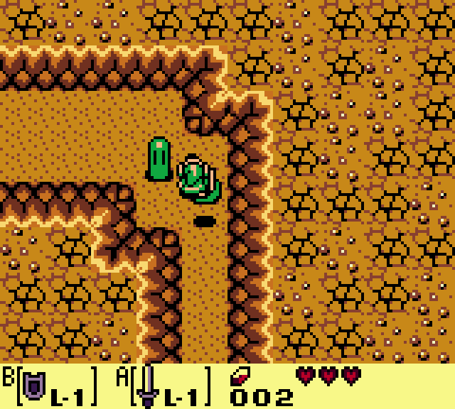 Still frame: Link in a narrow orange cave passage that turns a corner.